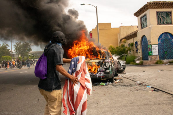 A figure rushes toward the flames, unafraid. With smoke rising into the sky, this image is more than protest—it’s confrontation, it’s the ignition of truth in a country that thrives on suppression. This piece forces the viewer to reckon with the cost of silence.
